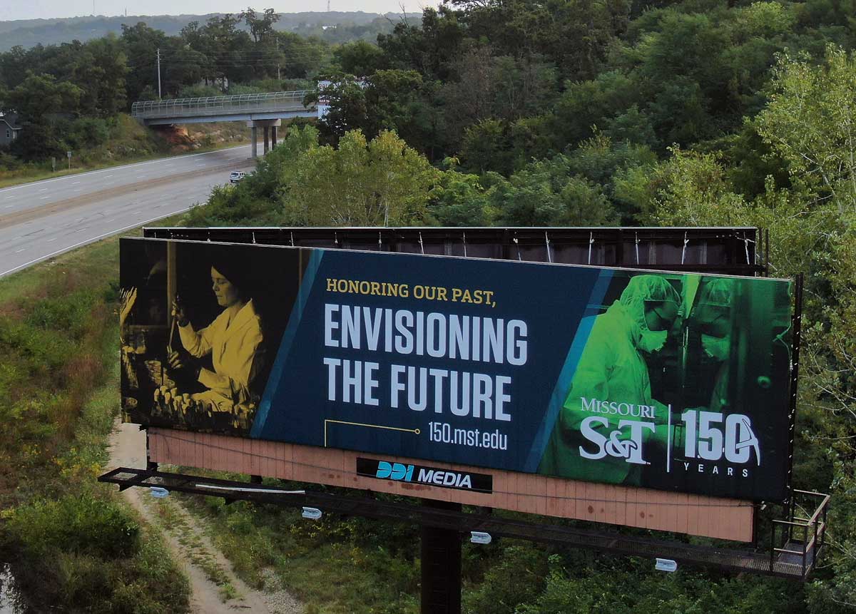 Billboard with historic photo of woman in a lab to the left, text in the middle reading 